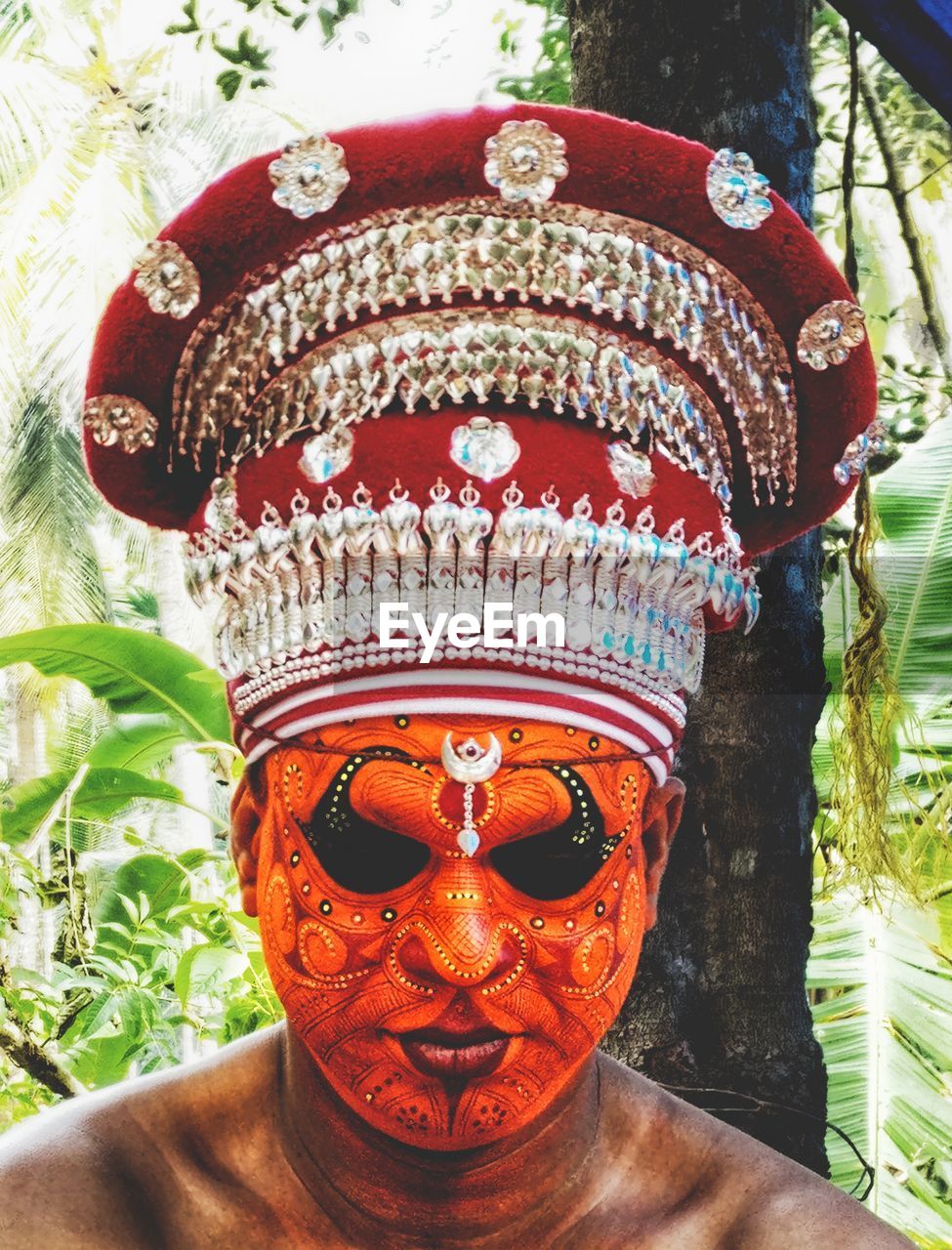 CLOSE-UP OF HUMAN MASK IN TRADITIONAL TEMPLE