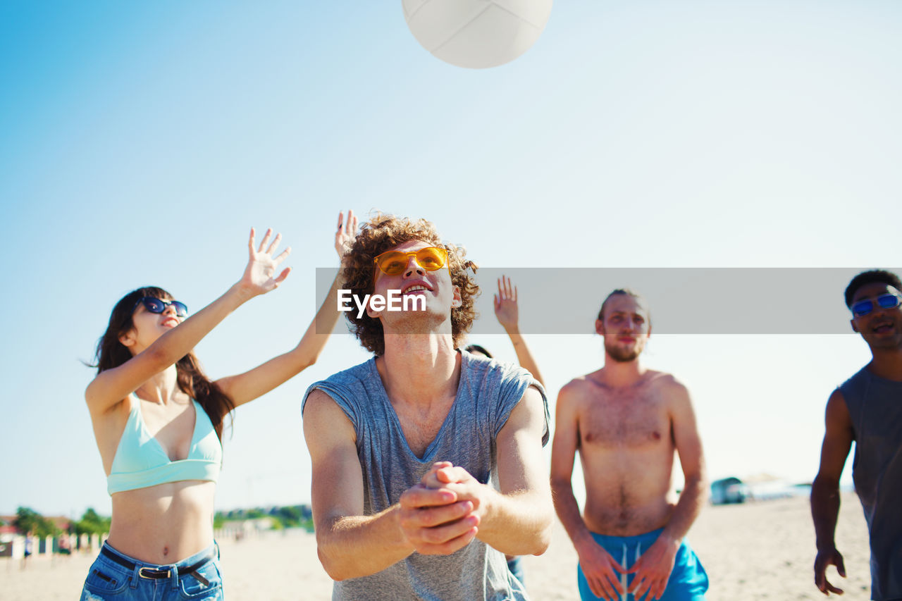 GROUP OF PEOPLE ENJOYING AT BEACH