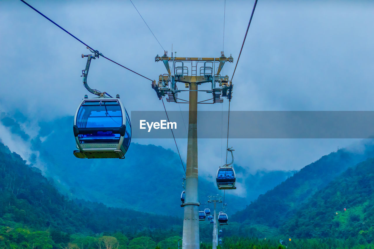 OVERHEAD CABLE CARS AGAINST SKY