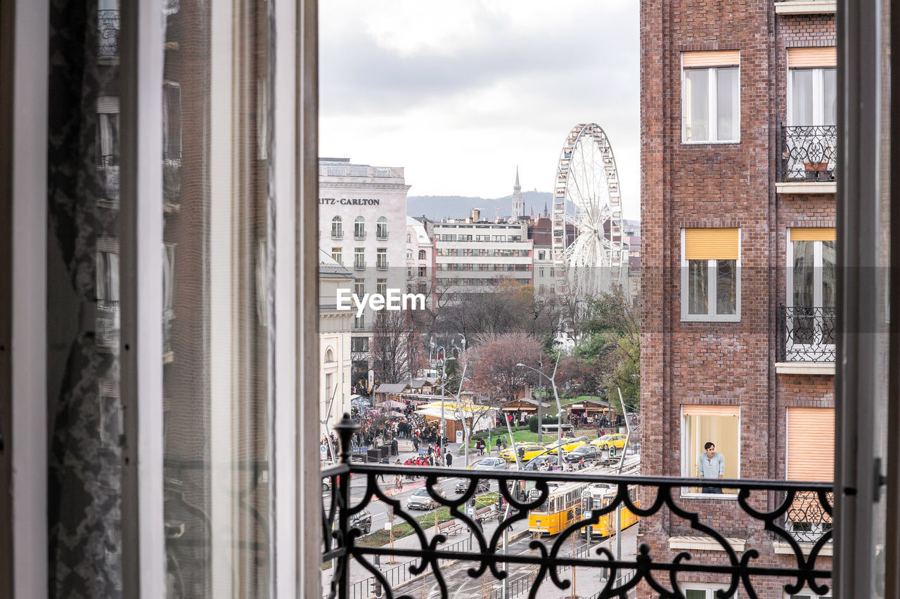 BUILDINGS AGAINST SKY SEEN THROUGH WINDOW