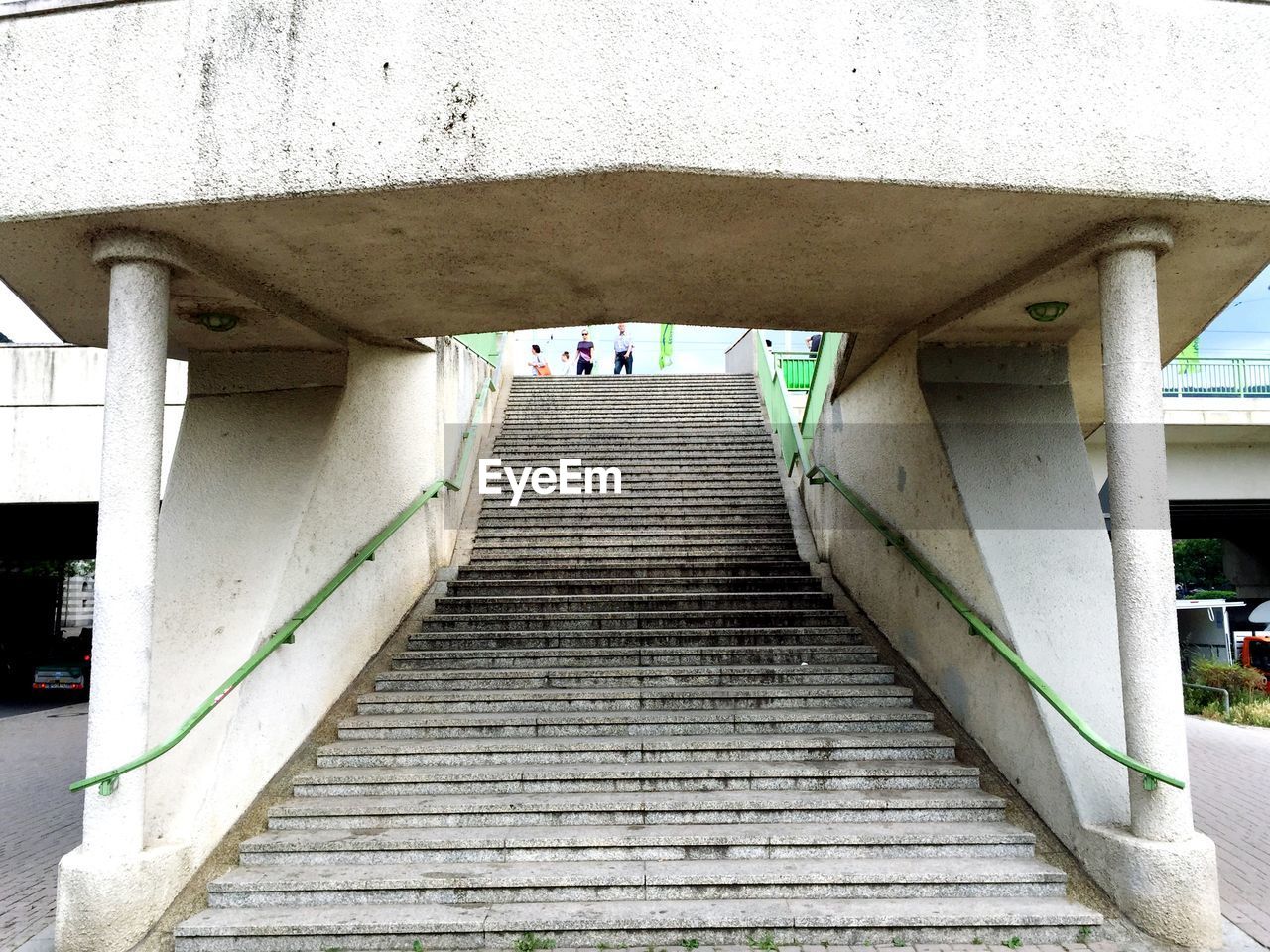 People standing by staircase in city