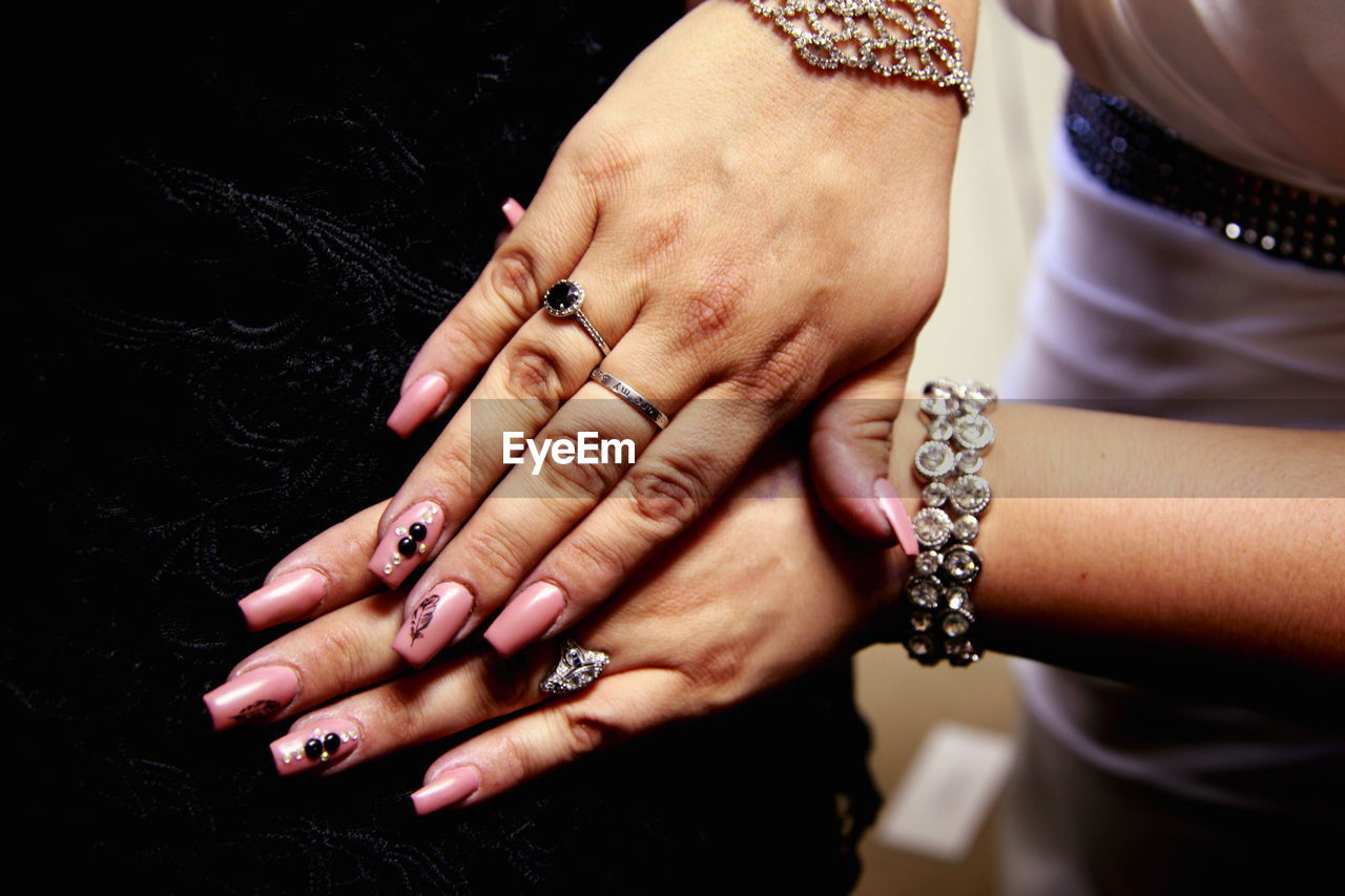 Cropped image of woman hands on black velvet