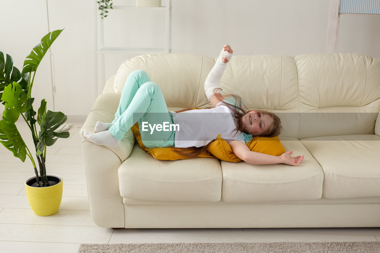 Girl lying on sofa at home