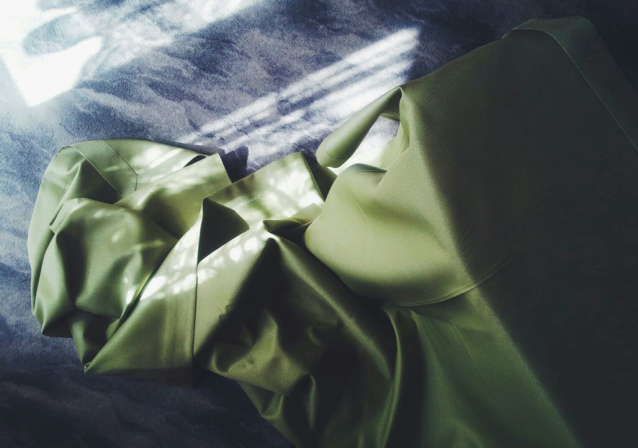 High angle view of green tablecloth on ironing board at home