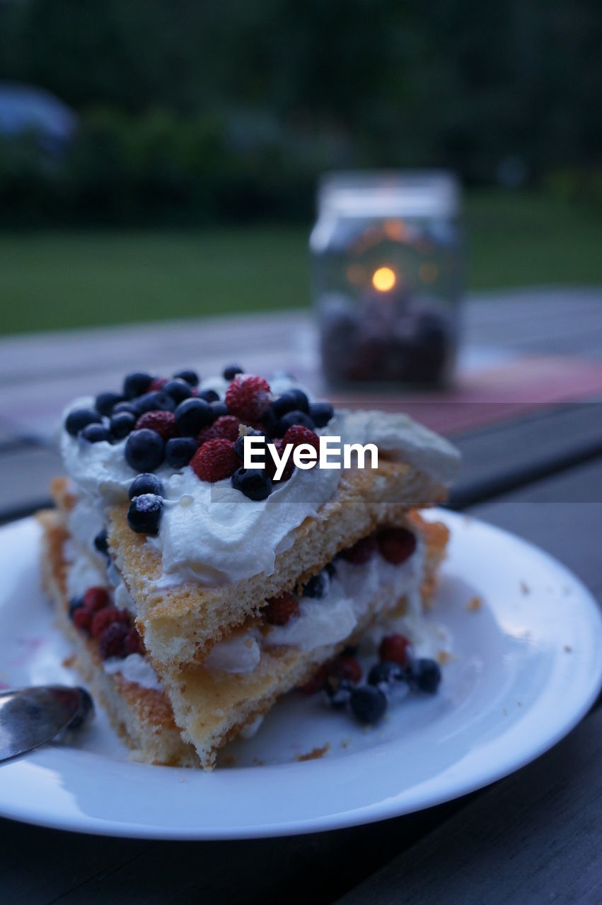 Close-up of pie slices served in plate on table at yard