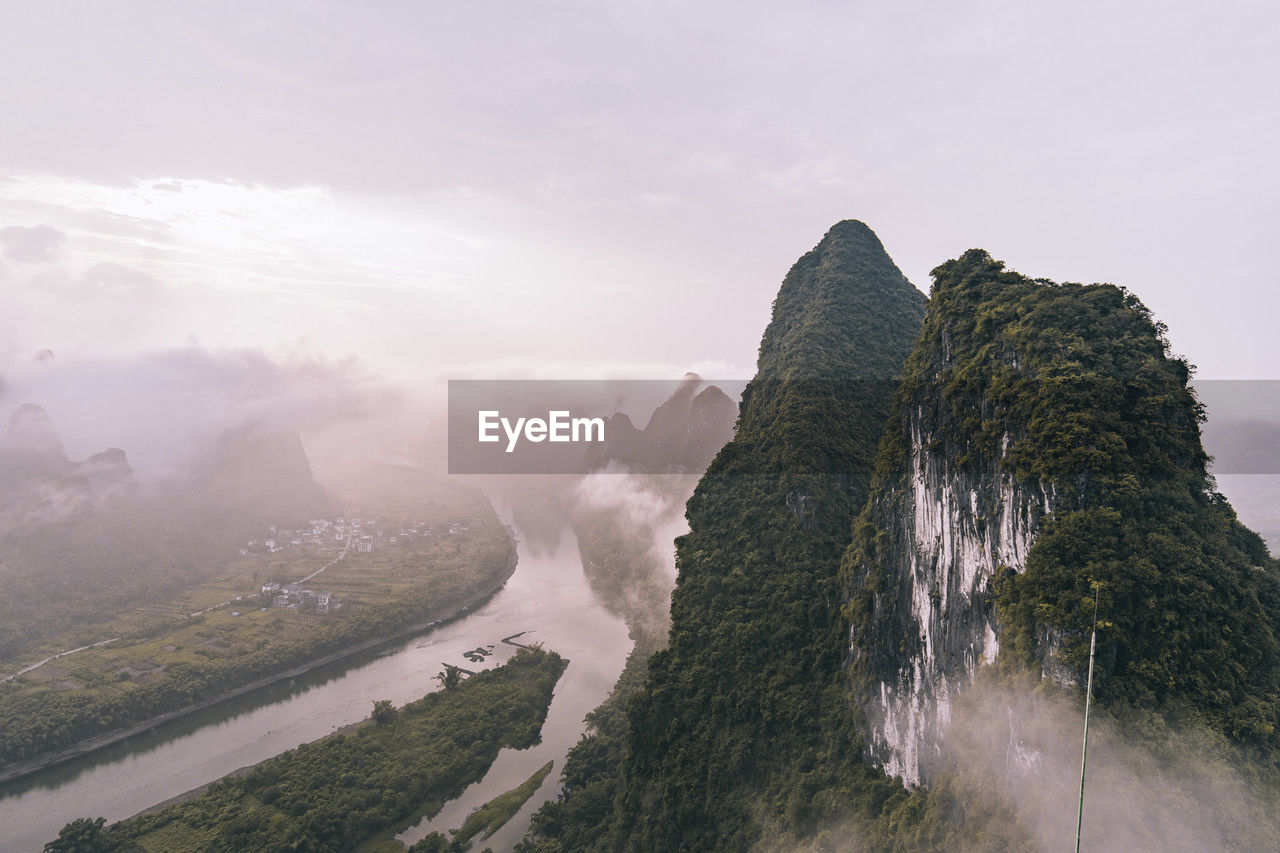 Hills under cloudy sky at sunrise, xingping town, guilin, china