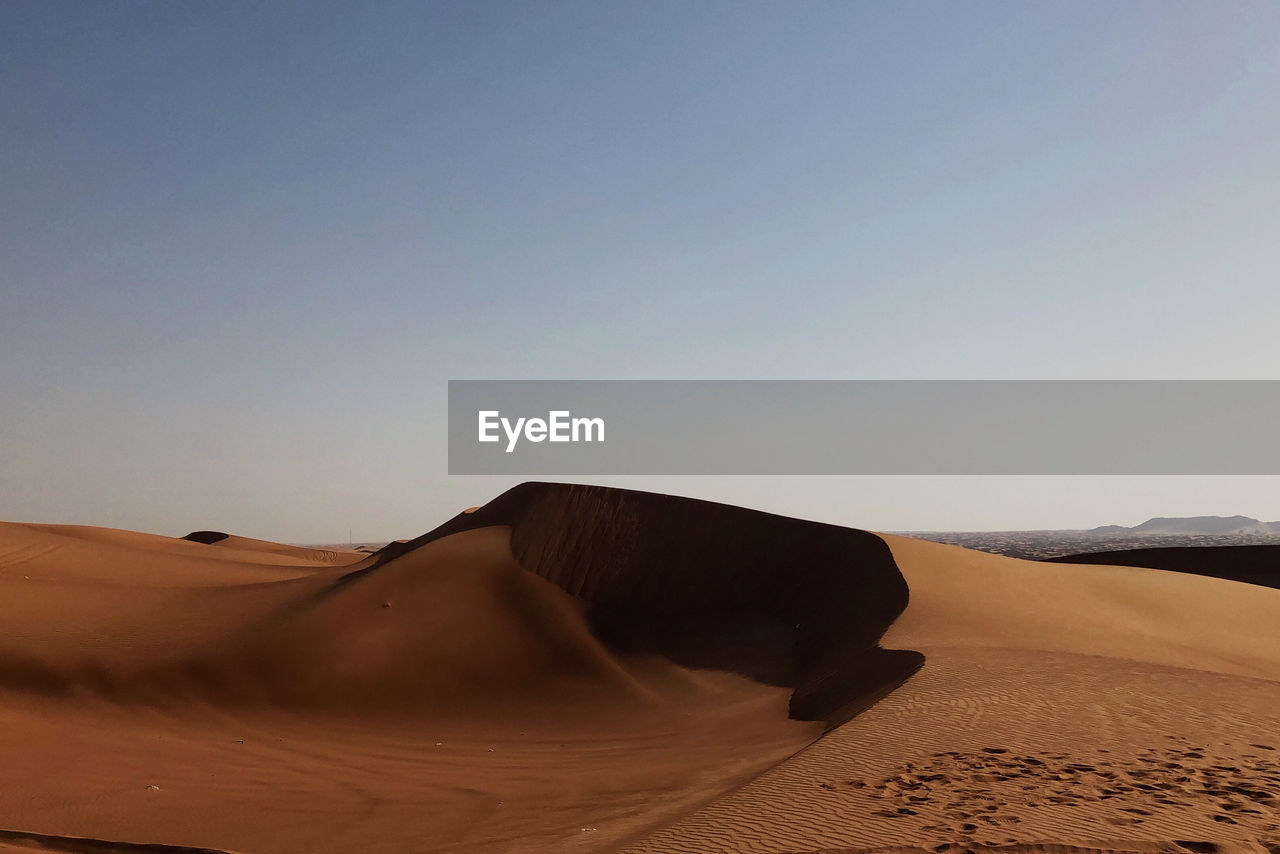 Scenic view of desert against clear sky