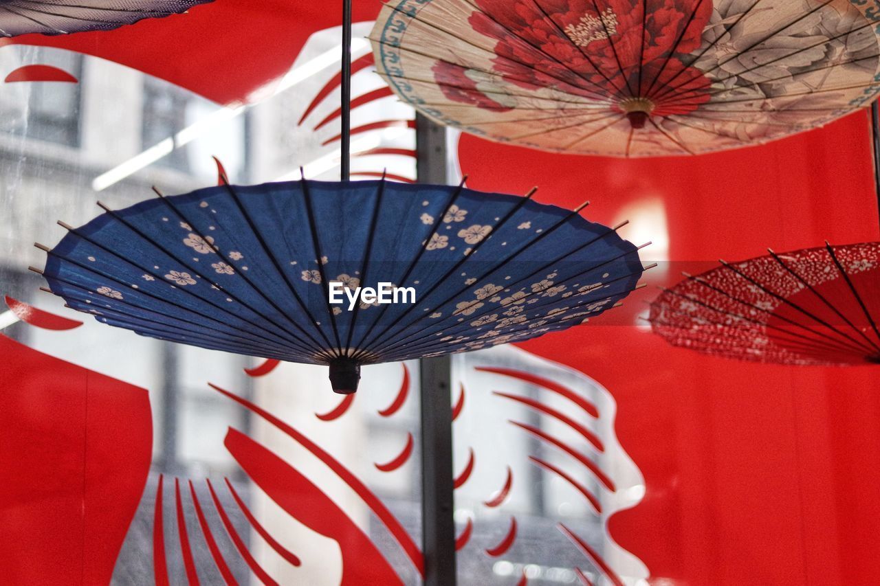 Close-up of umbrellas hanging outdoors
