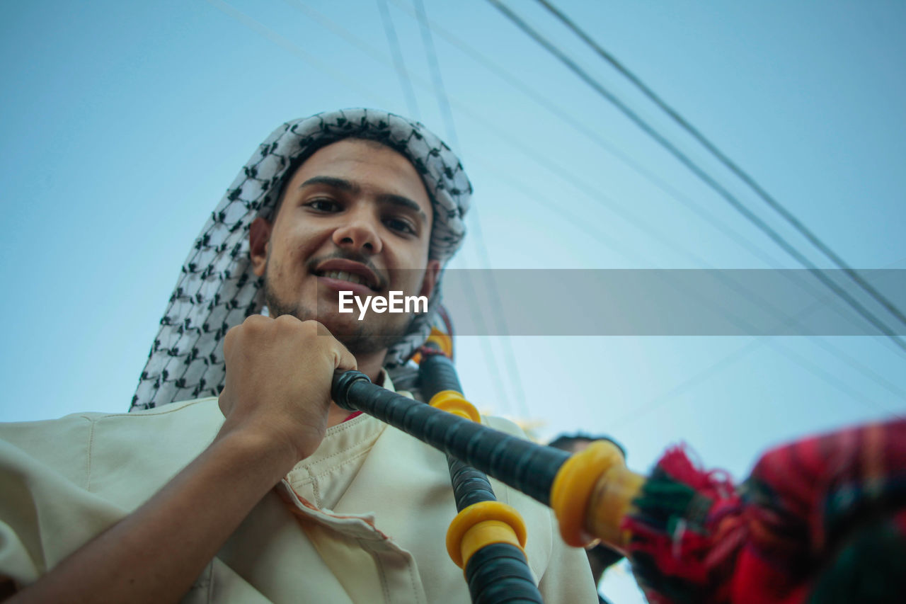  man holds a musician's instrument during the palestinian heritage day celebrations in gaza city