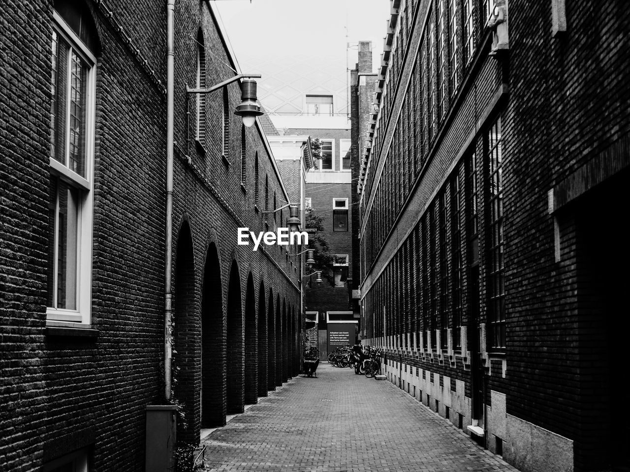 NARROW FOOTPATH AMIDST BUILDINGS IN CITY