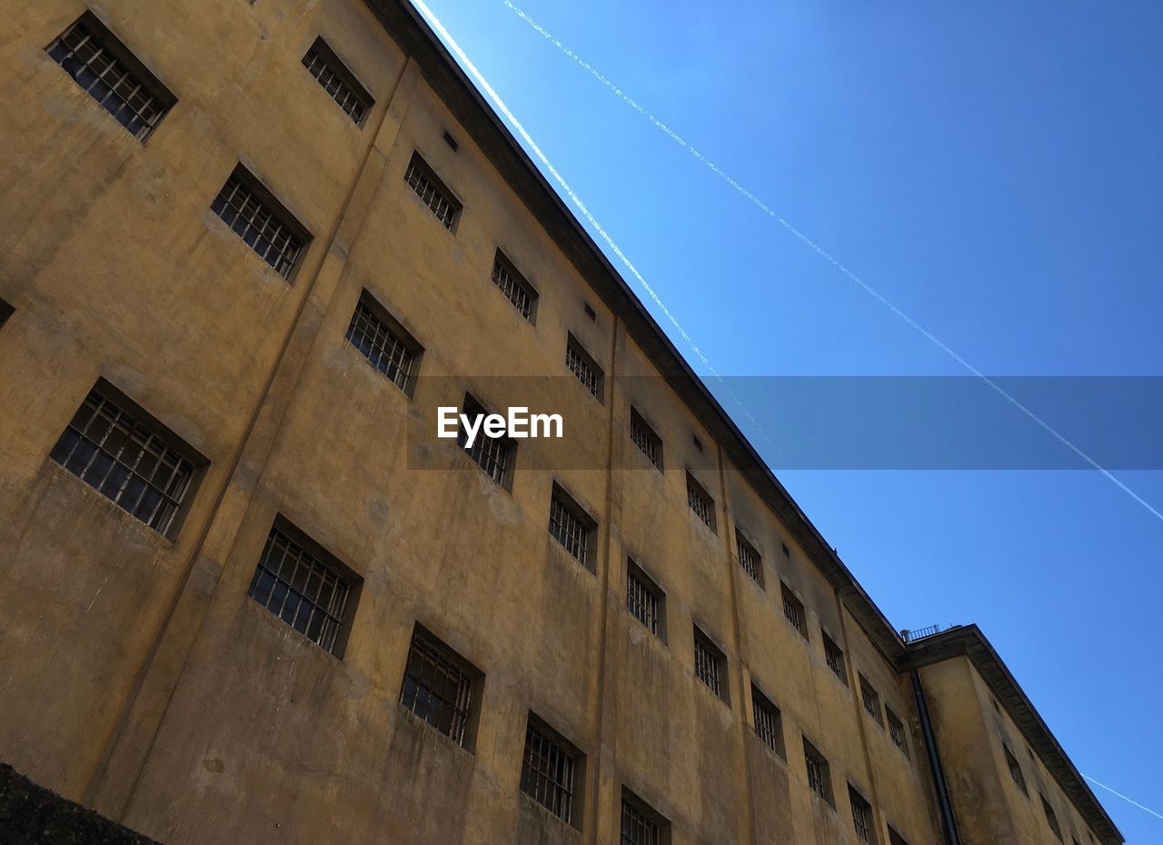 LOW ANGLE VIEW OF POWER LINES AGAINST BLUE SKY