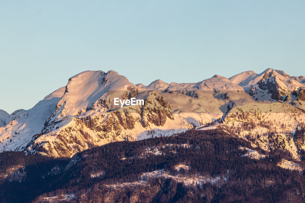 Scenic view of snowcapped mountains against clear sky