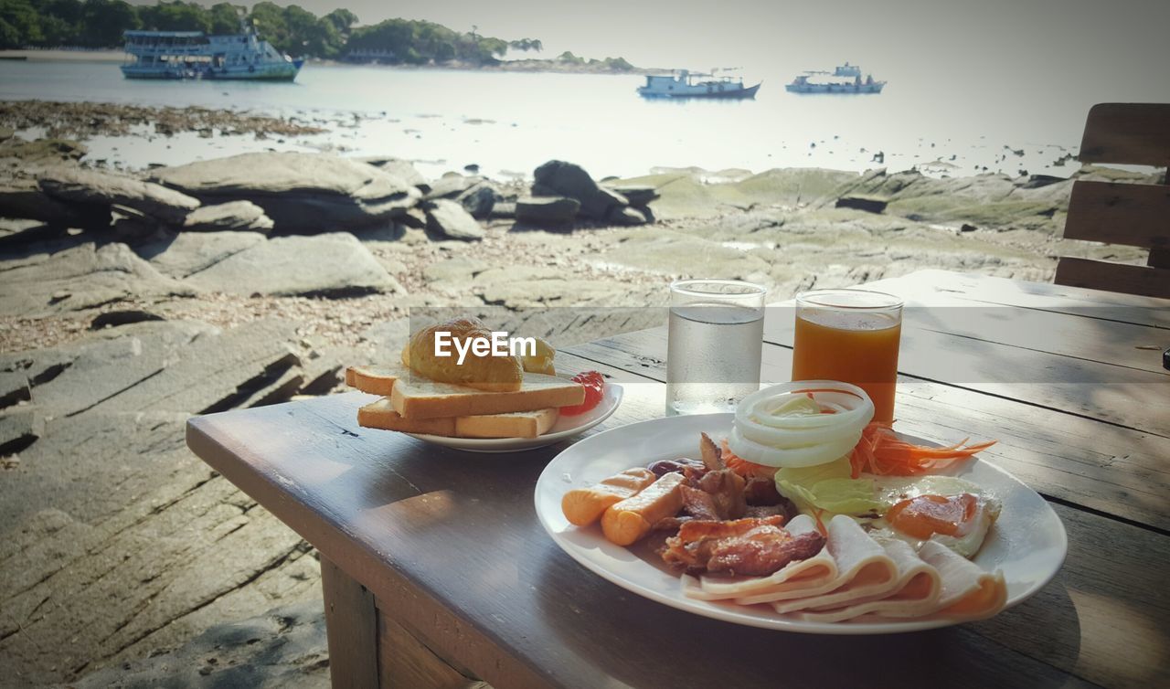 Close-up of food served on table at beach