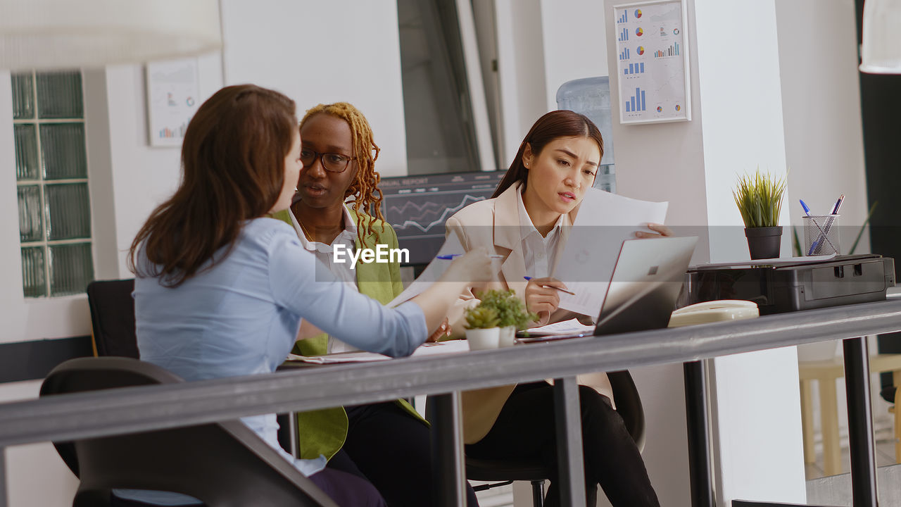 business colleagues stacking hands in office