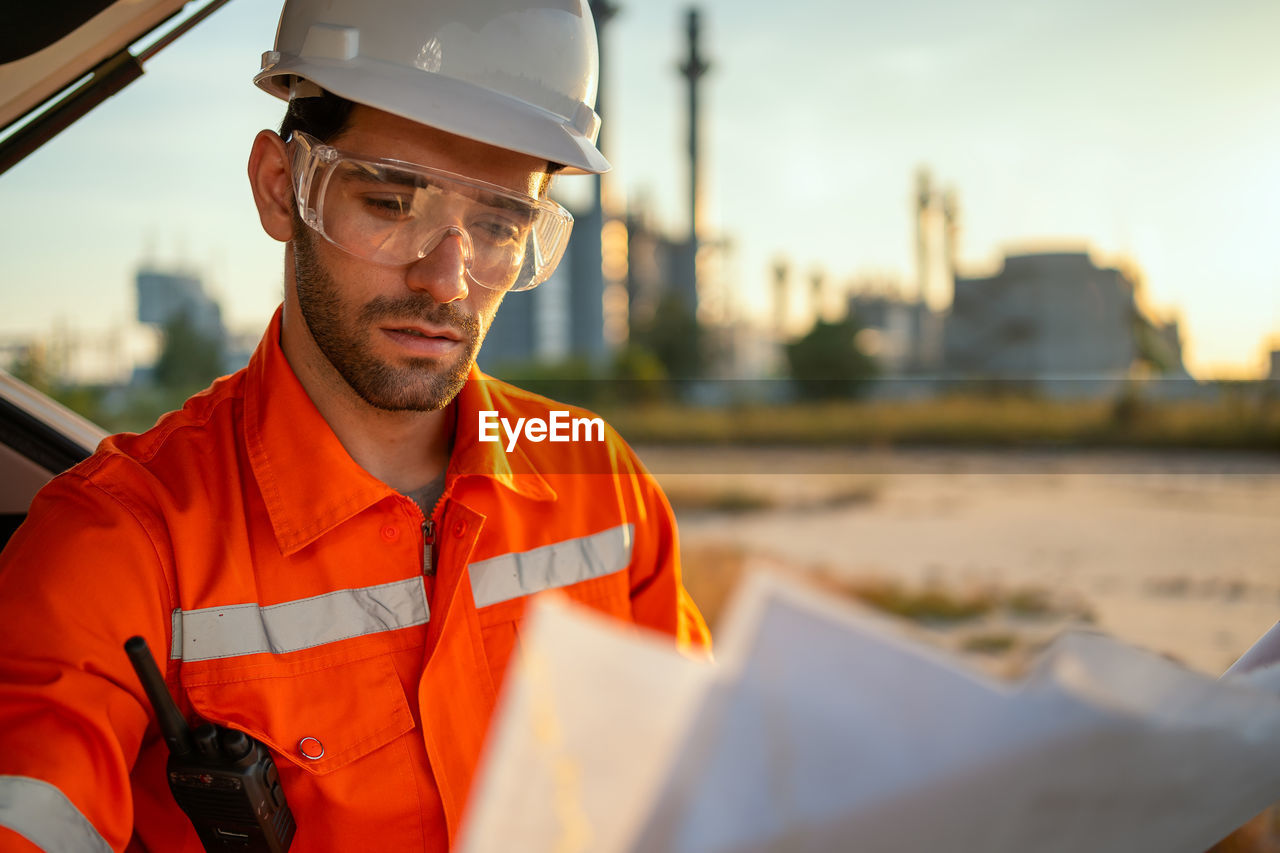 Engineer looking at refinery plans.