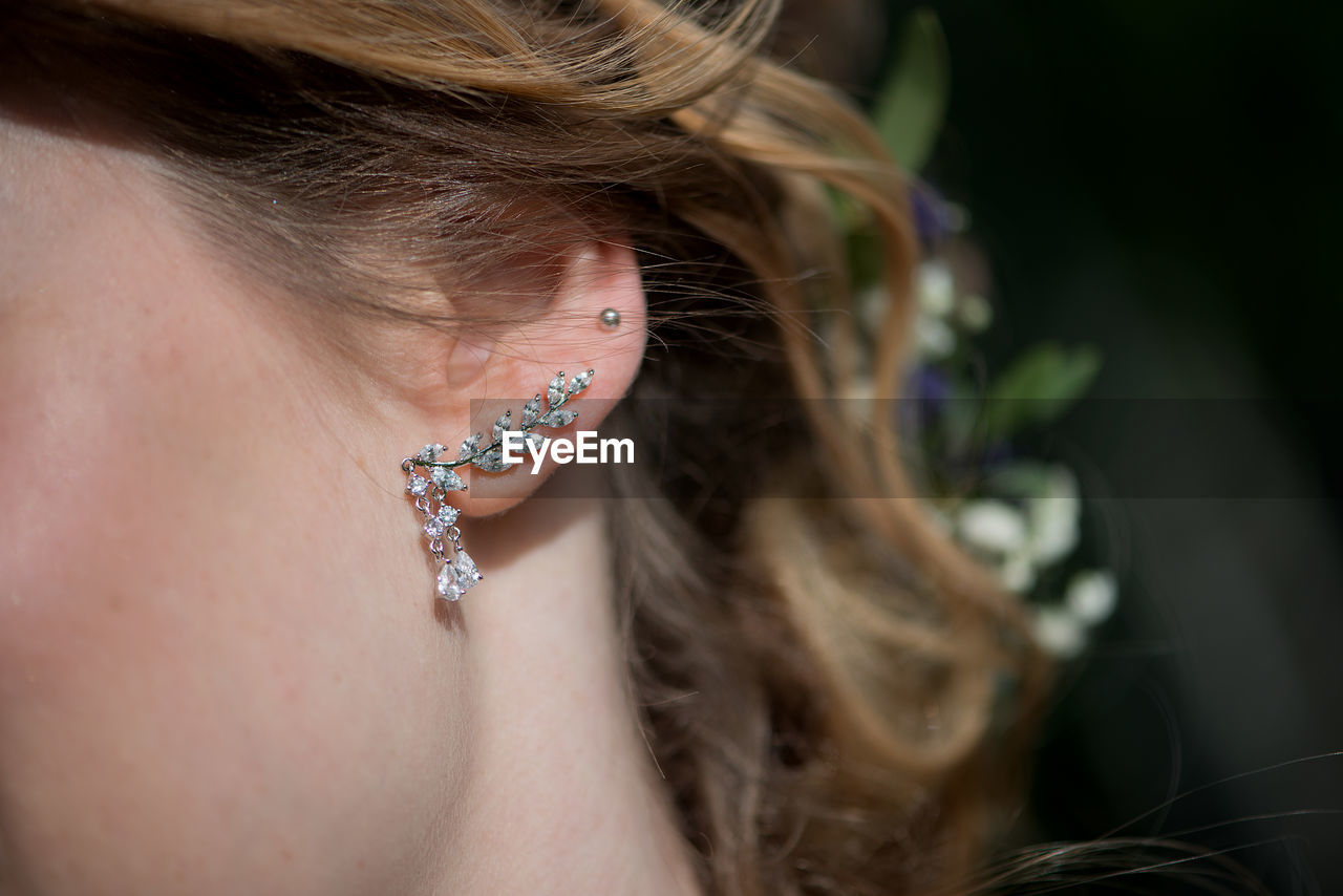 Cropped image of bride wearing diamond earring