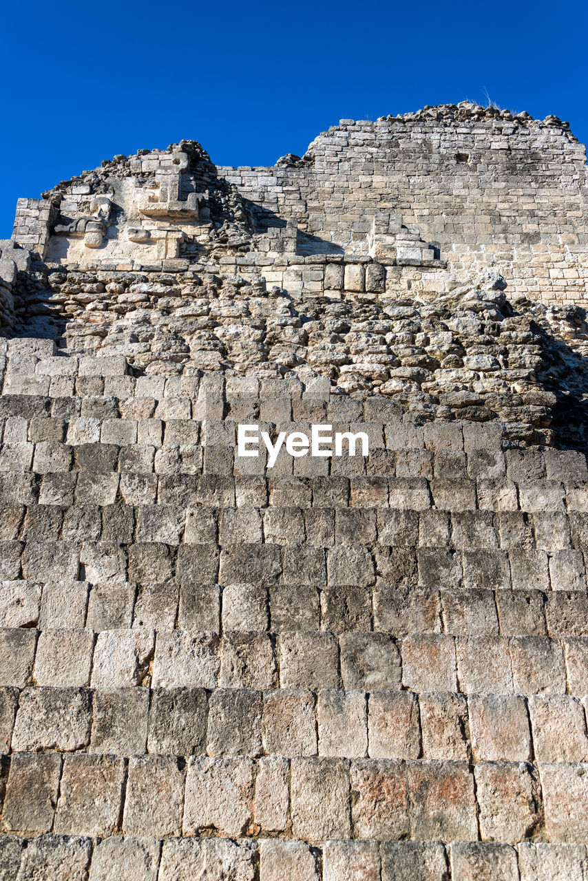 Low angle view of mayan ruins at becan on sunny day