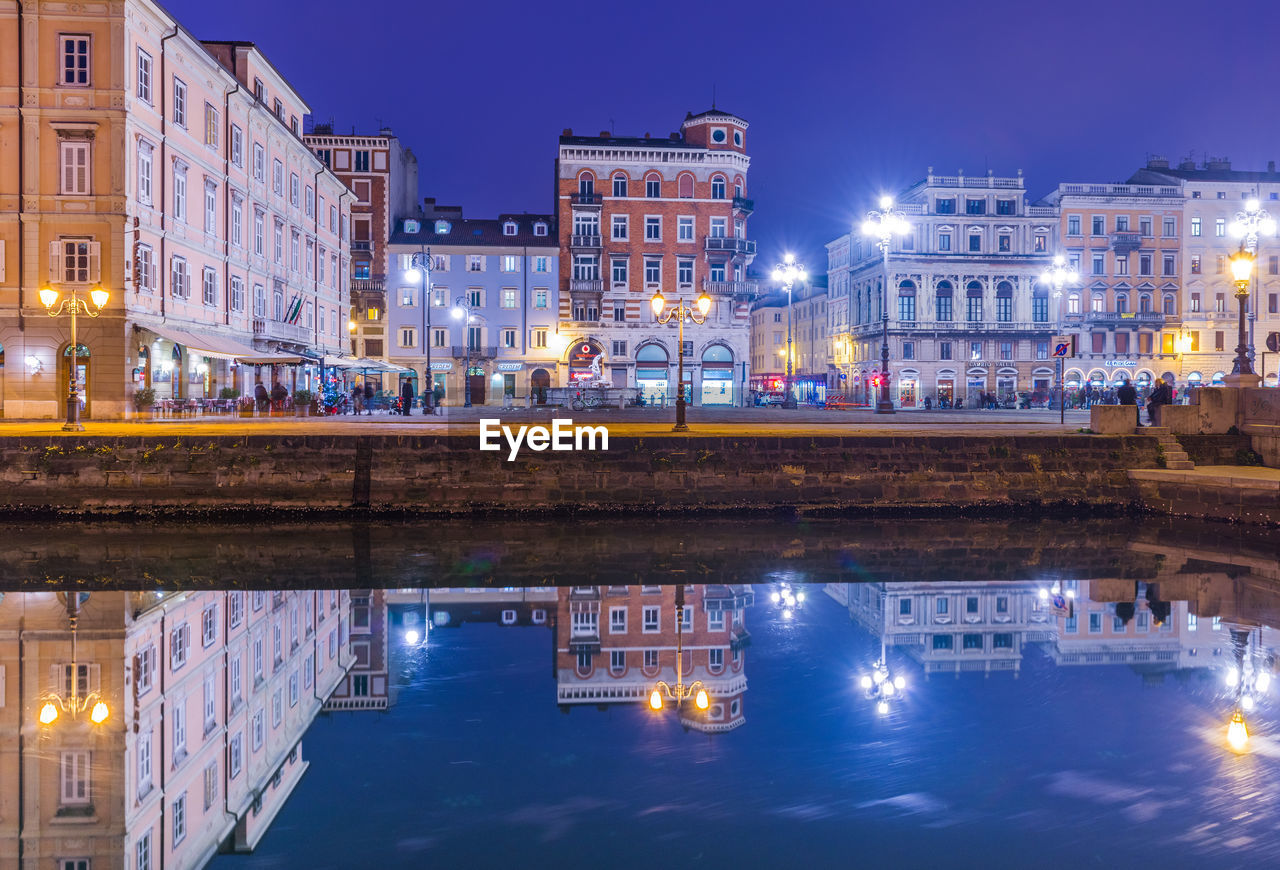 reflection of illuminated buildings in city