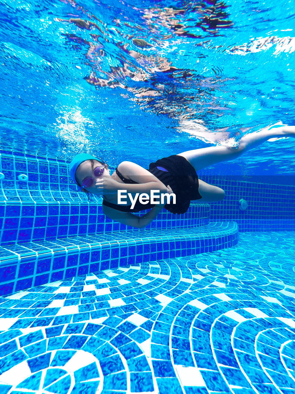 Portrait of girl swimming in pool