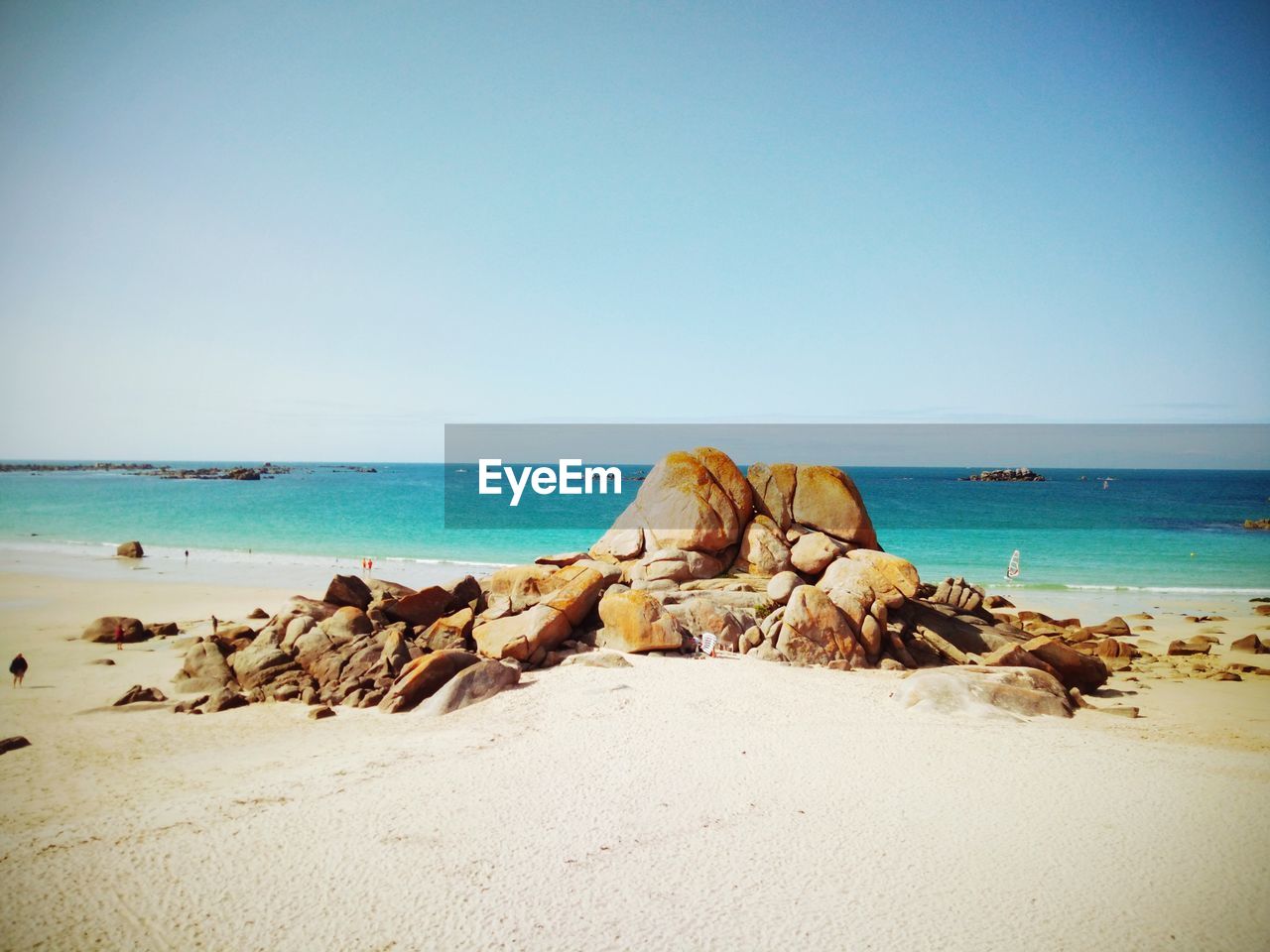 SCENIC VIEW OF ROCKS ON BEACH AGAINST CLEAR SKY