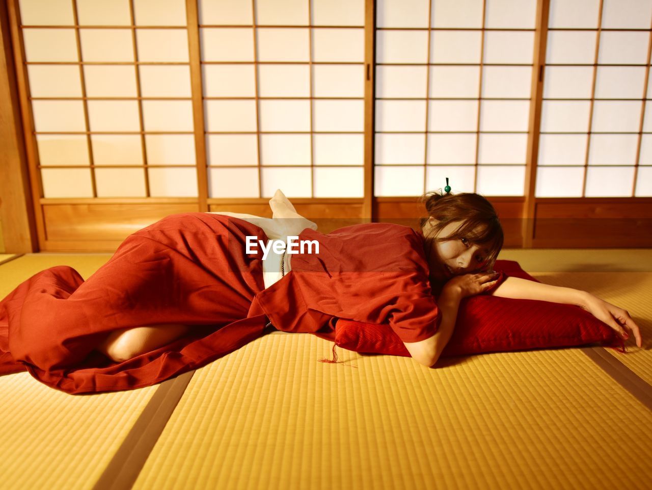 Young woman lying on floor at home