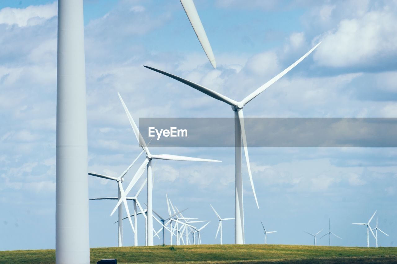 TRADITIONAL WINDMILL ON FIELD AGAINST SKY