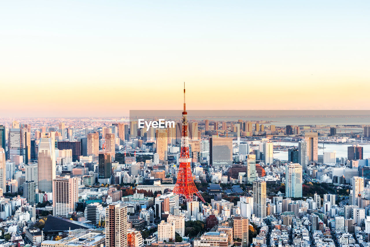 High angle view of city buildings against sky during sunset