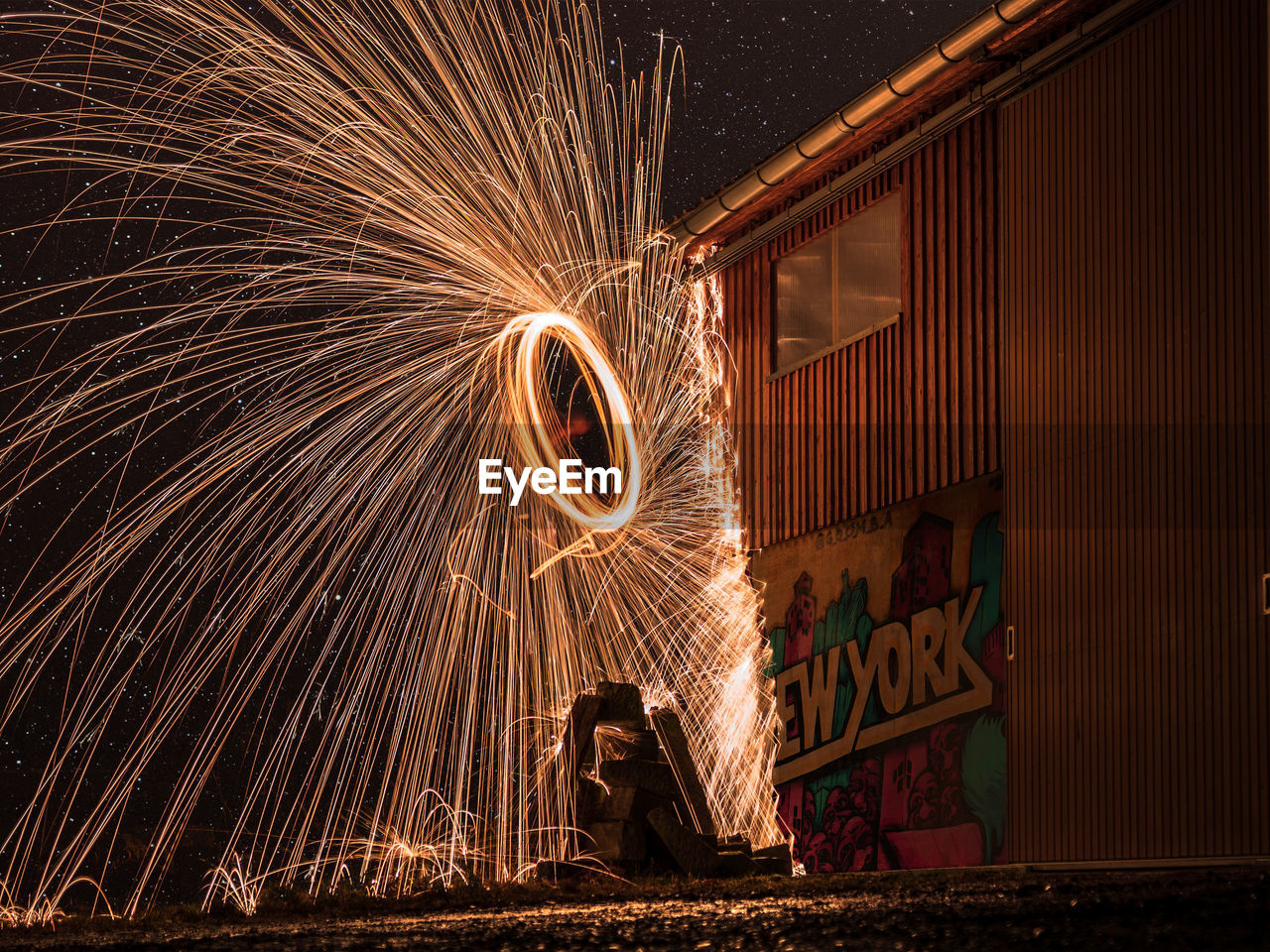 Low angle view of firework display at night