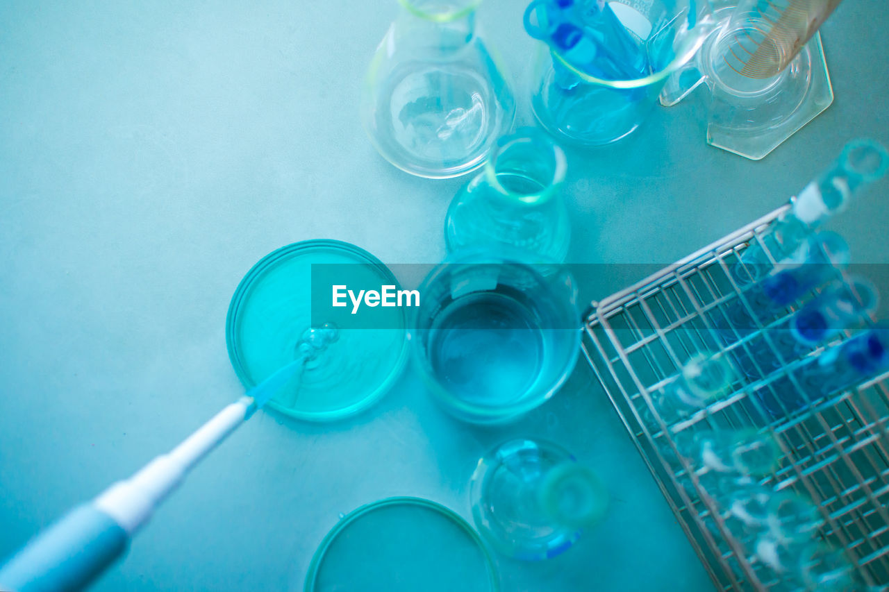 Close-up of laboratory glassware against blue background