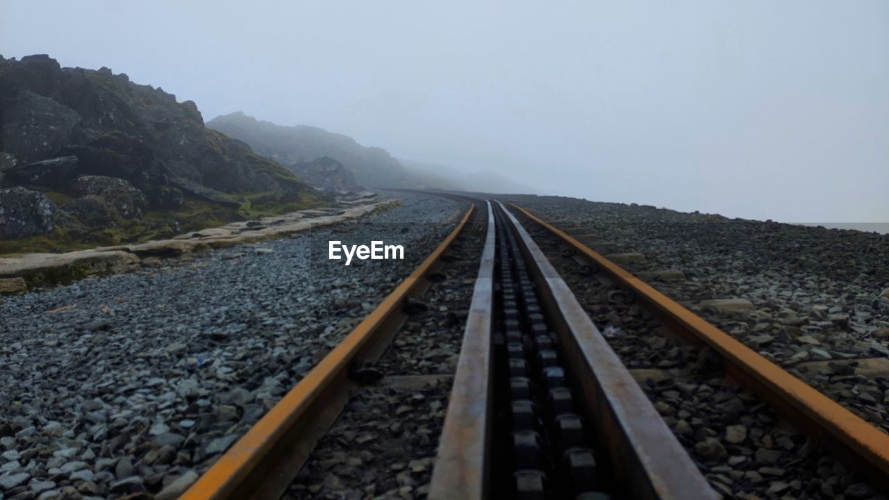 Surface level of railroad track against sky