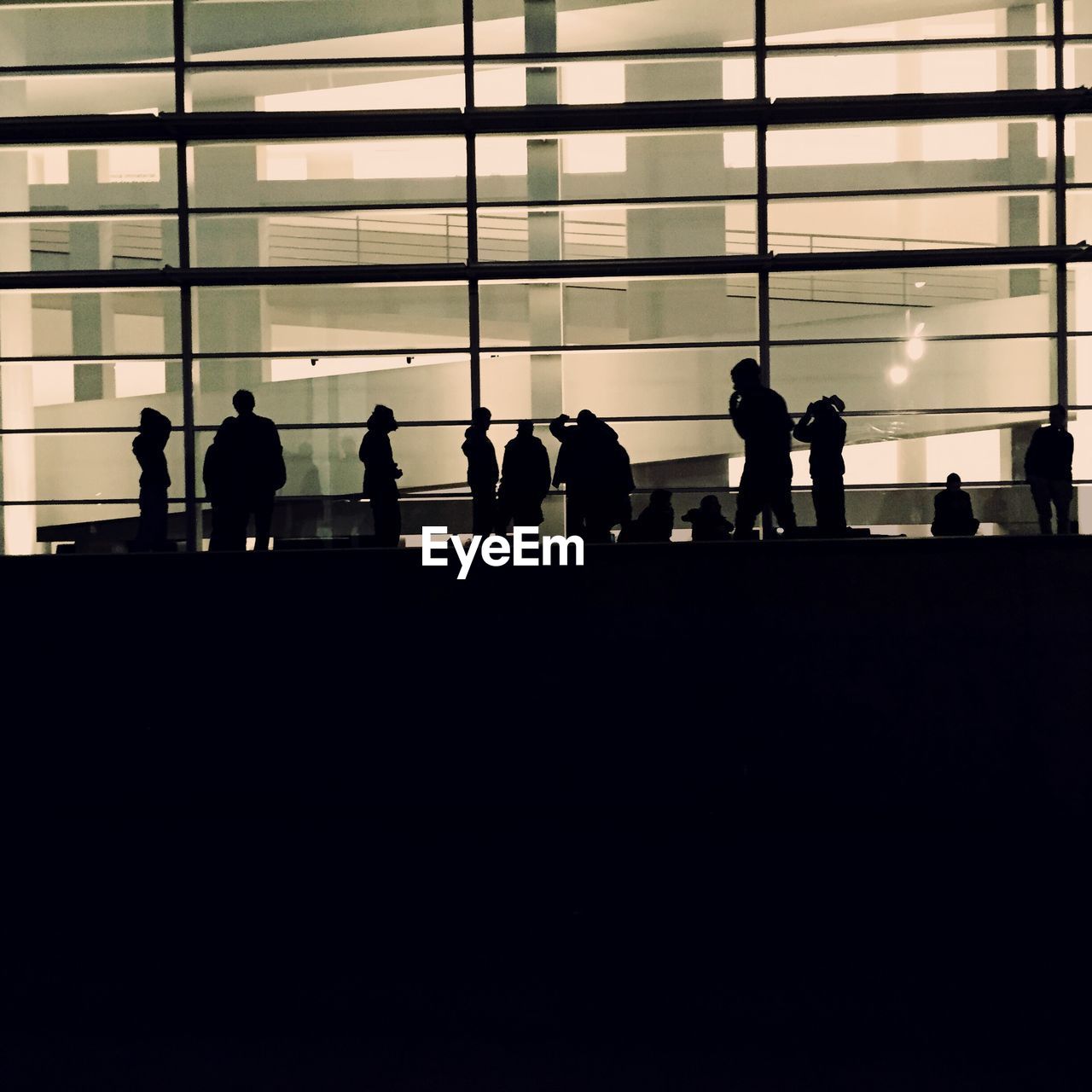Silhouette people in modern building