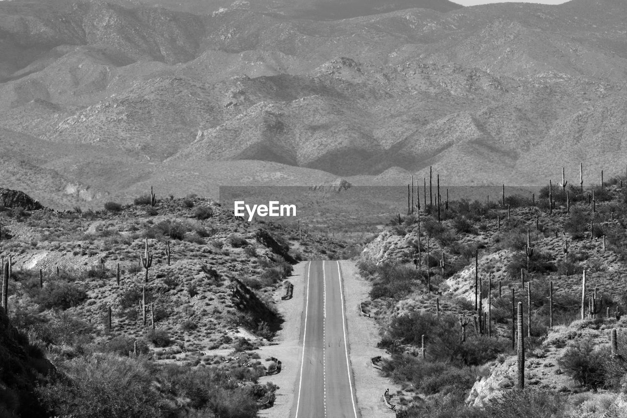 High angle view of road amidst trees and mountains