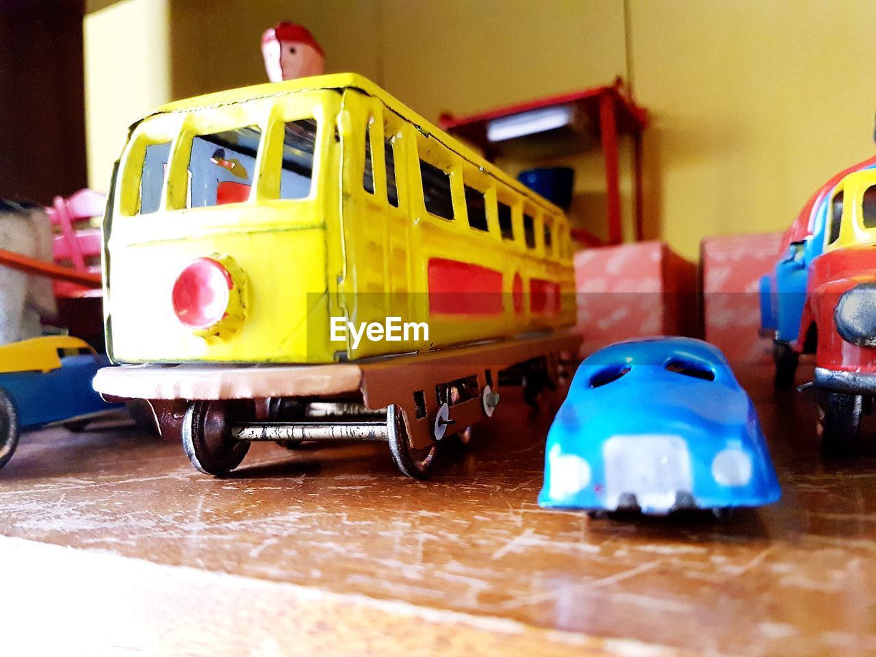 CLOSE-UP OF TOY CAR AGAINST BLUE WALL