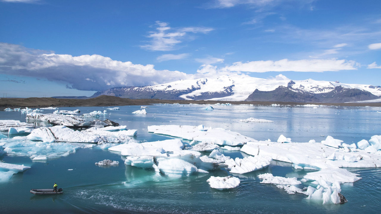 SCENIC VIEW OF LAKE AGAINST MOUNTAIN RANGE