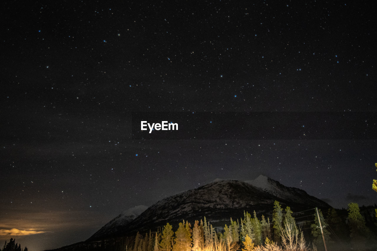 Scenic view of mountains against sky at night