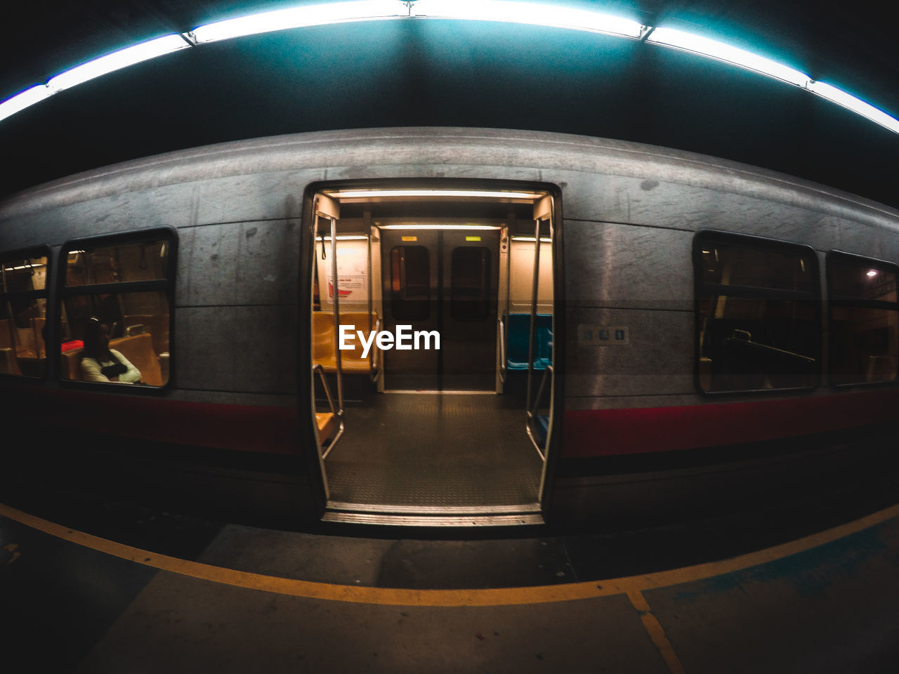 Fish-eye lens shot of train at subway station during night