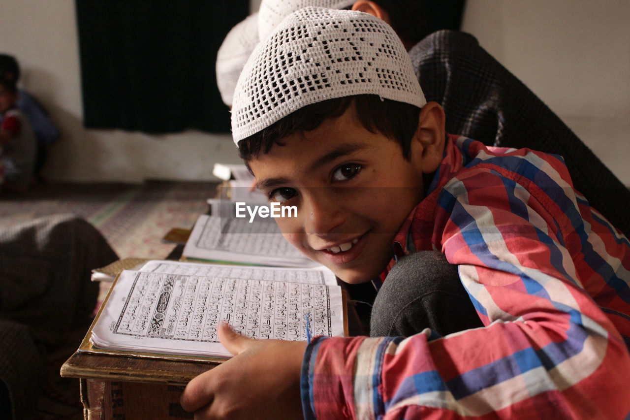Portrait of smiling boy with quran