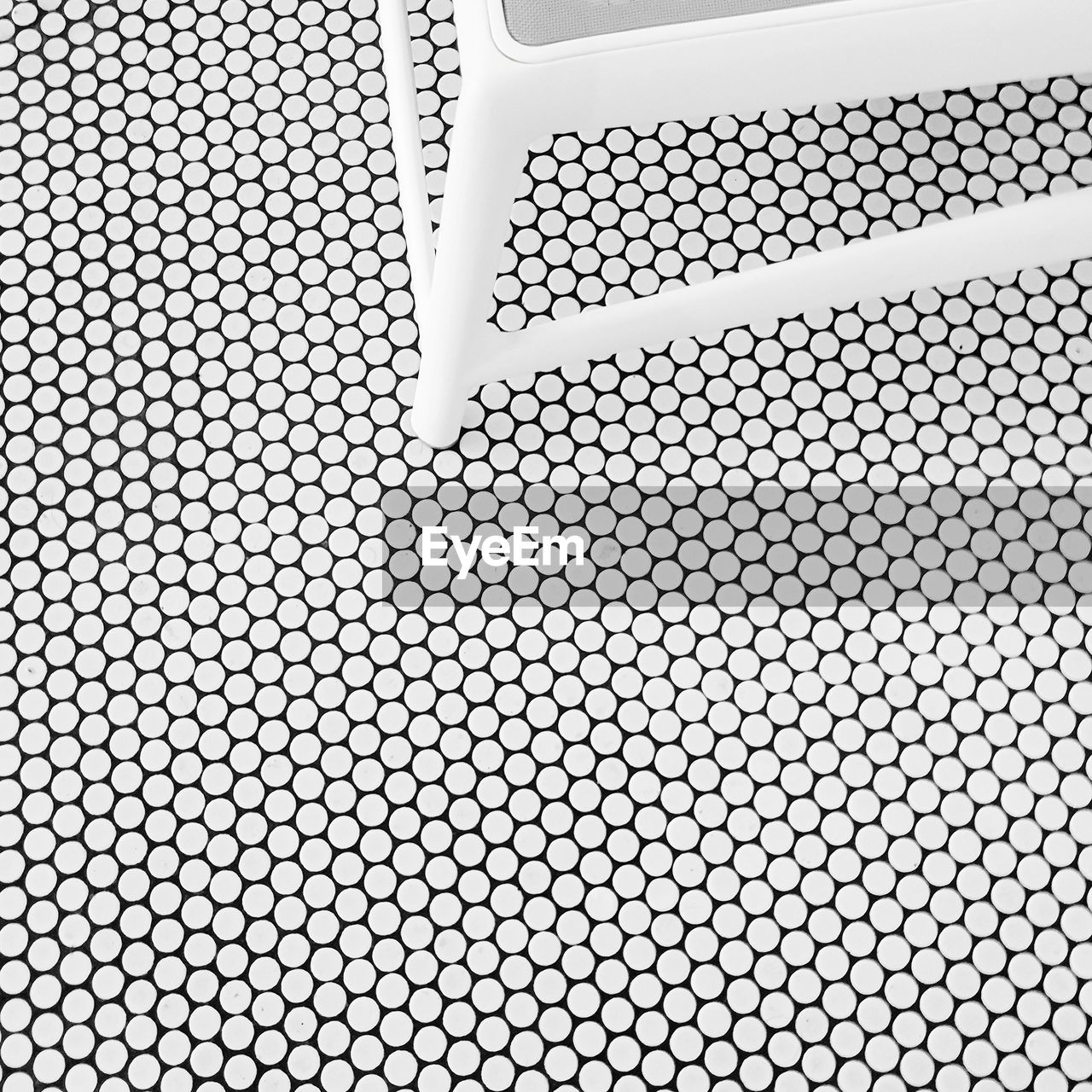 Close-up of chair on tiled floor