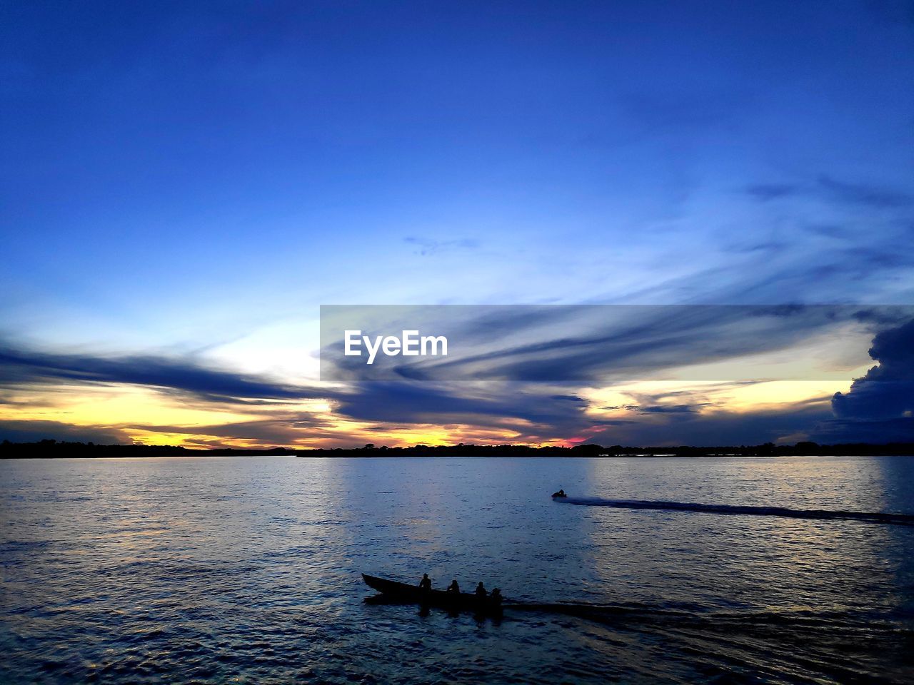 Scenic view of sea against sky at sunset