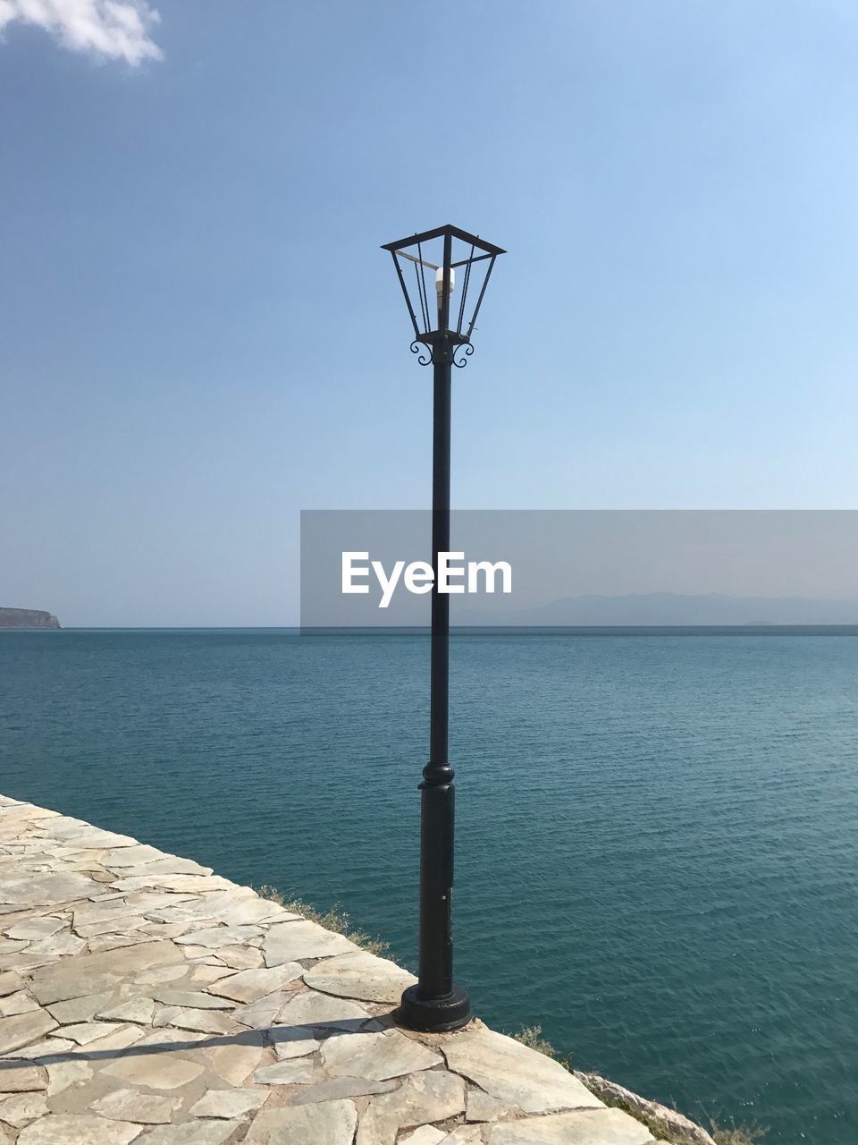 VIEW OF STREET LIGHT AGAINST SEA