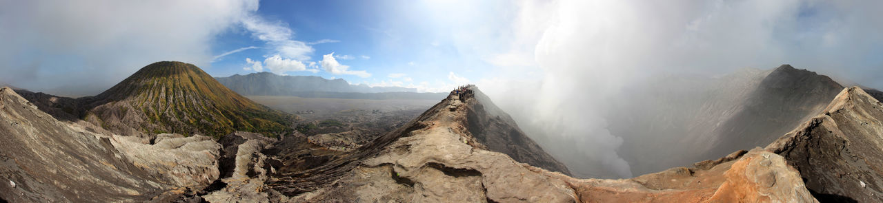 Scenic view of mountains against cloudy sky