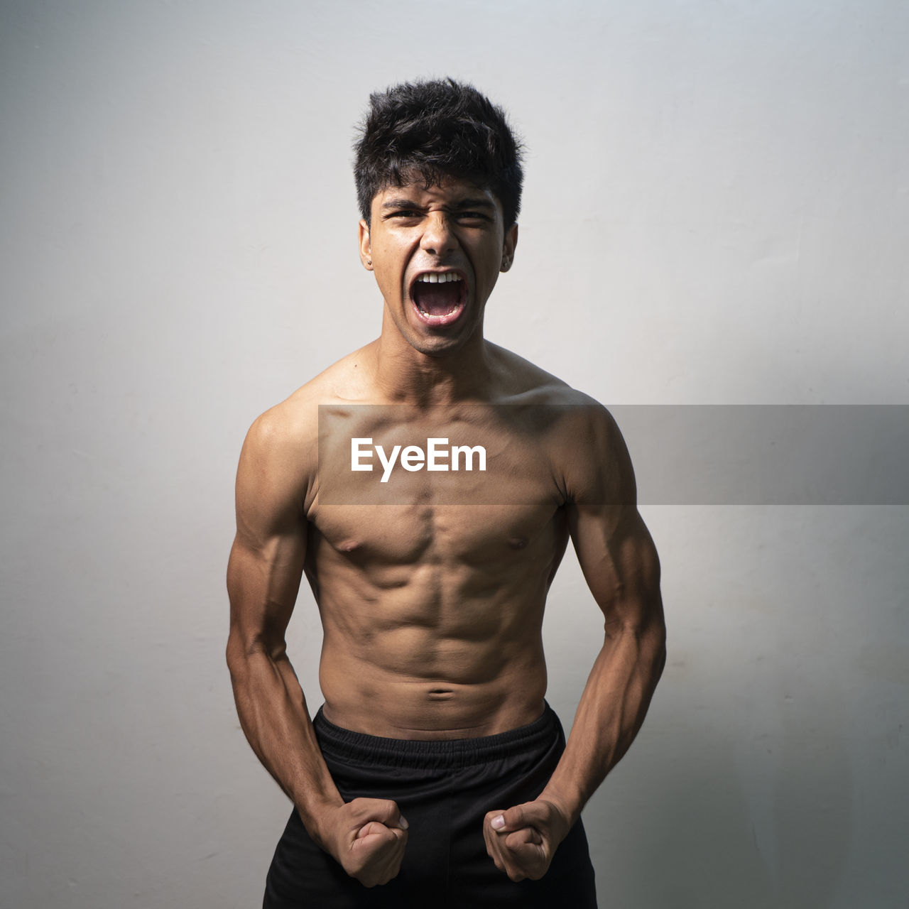 Dramatic portrait of a young athlete, shouting on the camera.