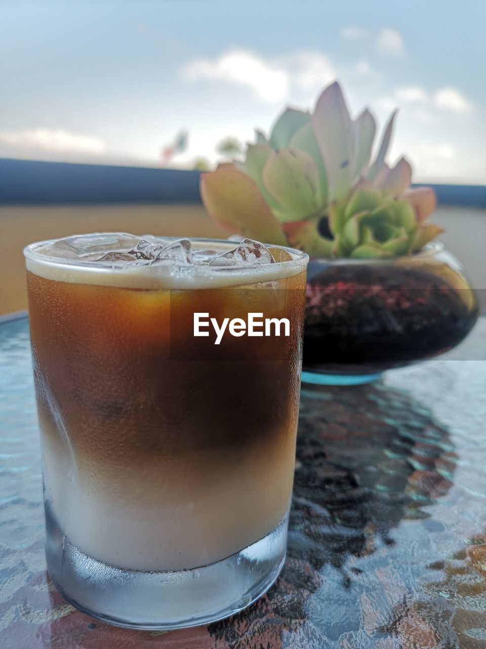 CLOSE-UP OF COFFEE WITH GLASS OF JUICE