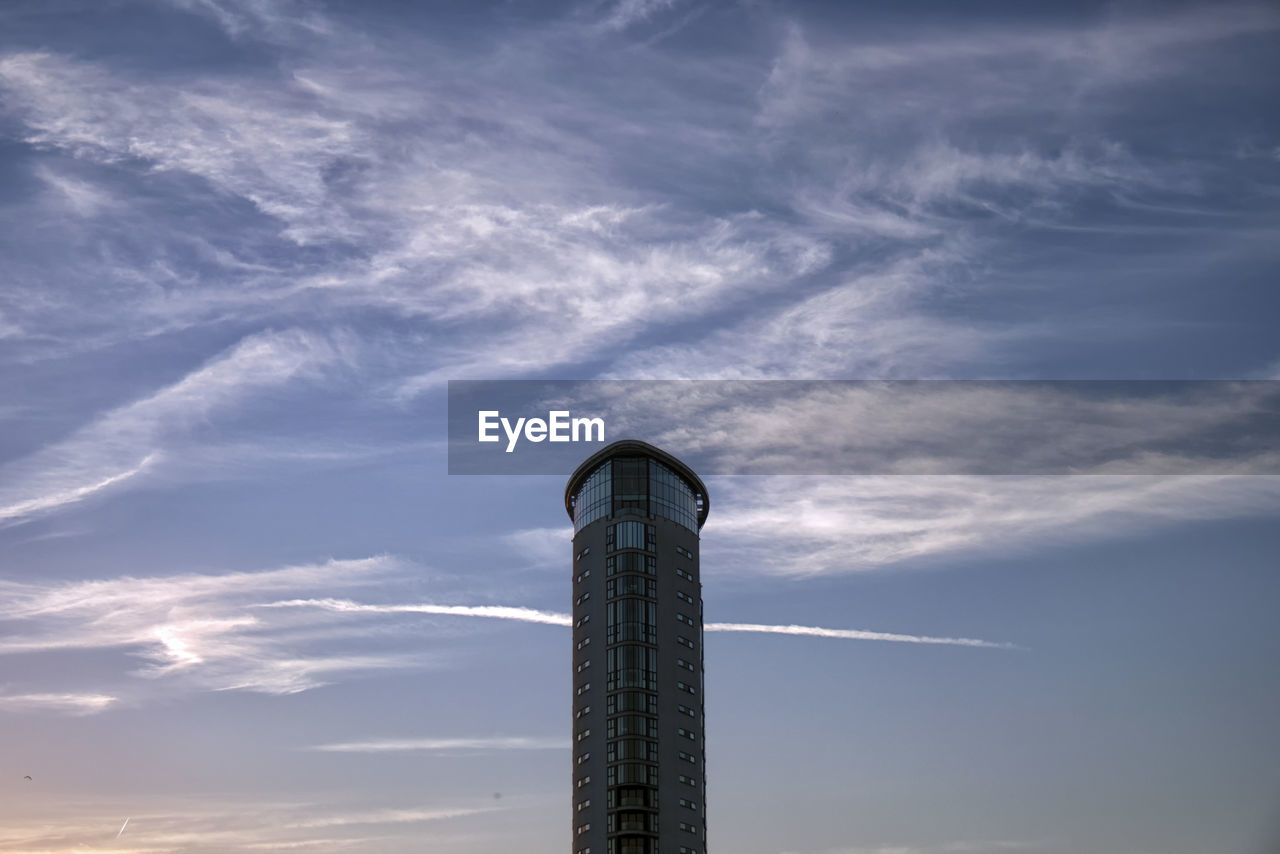 LOW ANGLE VIEW OF SMOKE STACK BY BUILDING AGAINST SKY