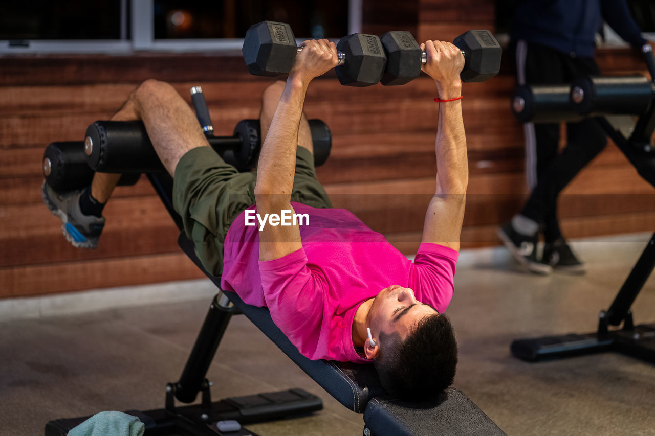 Rear view of man exercising in gym