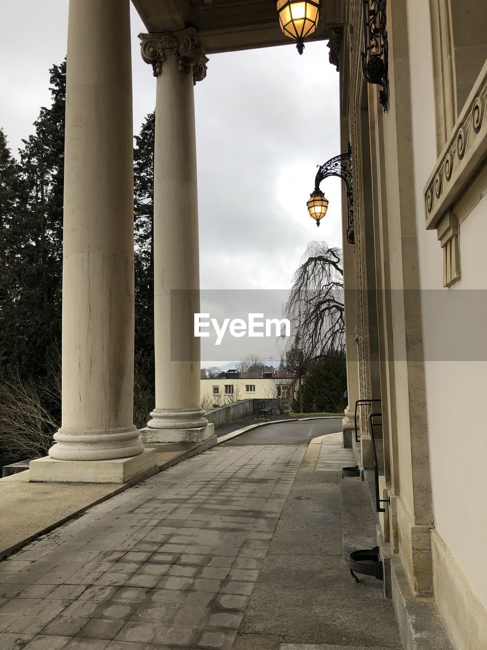 LOW ANGLE VIEW OF STREET LIGHT BY BUILDING