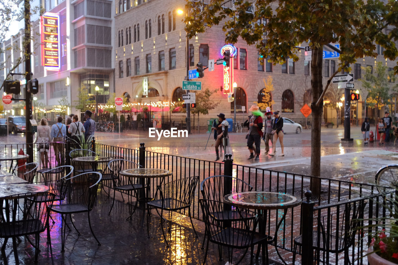 PEOPLE ON WET STREET IN CITY