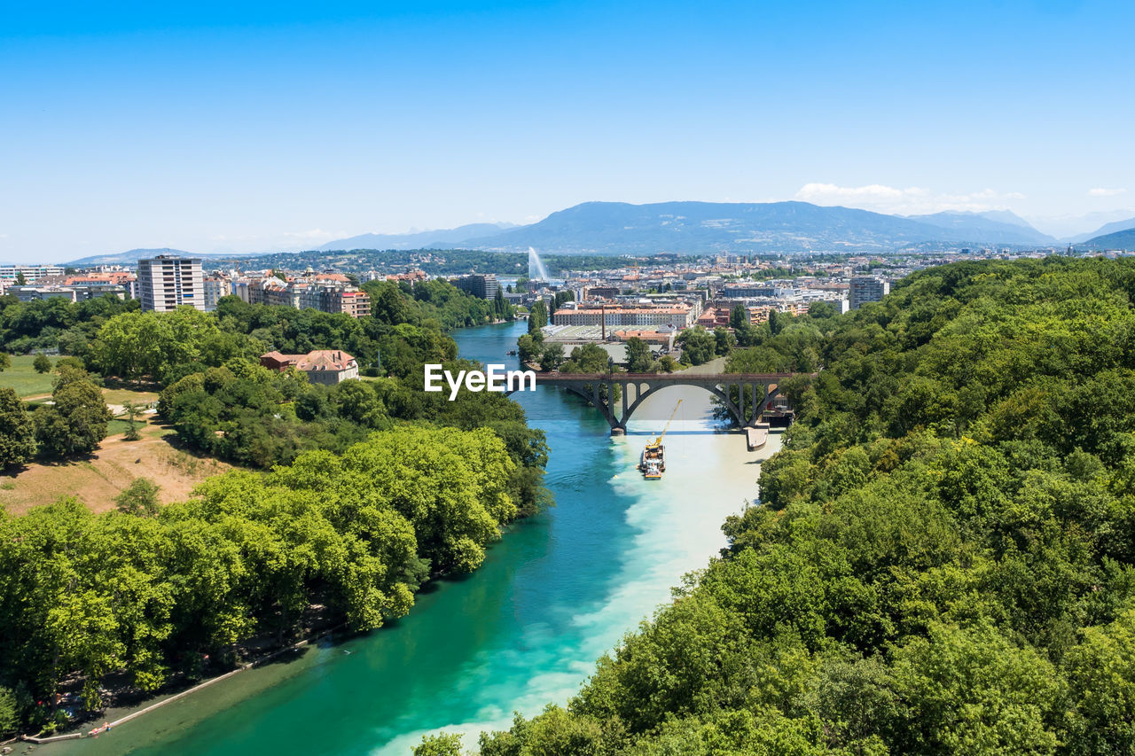 HIGH ANGLE VIEW OF RIVER AMIDST TREES AGAINST SKY
