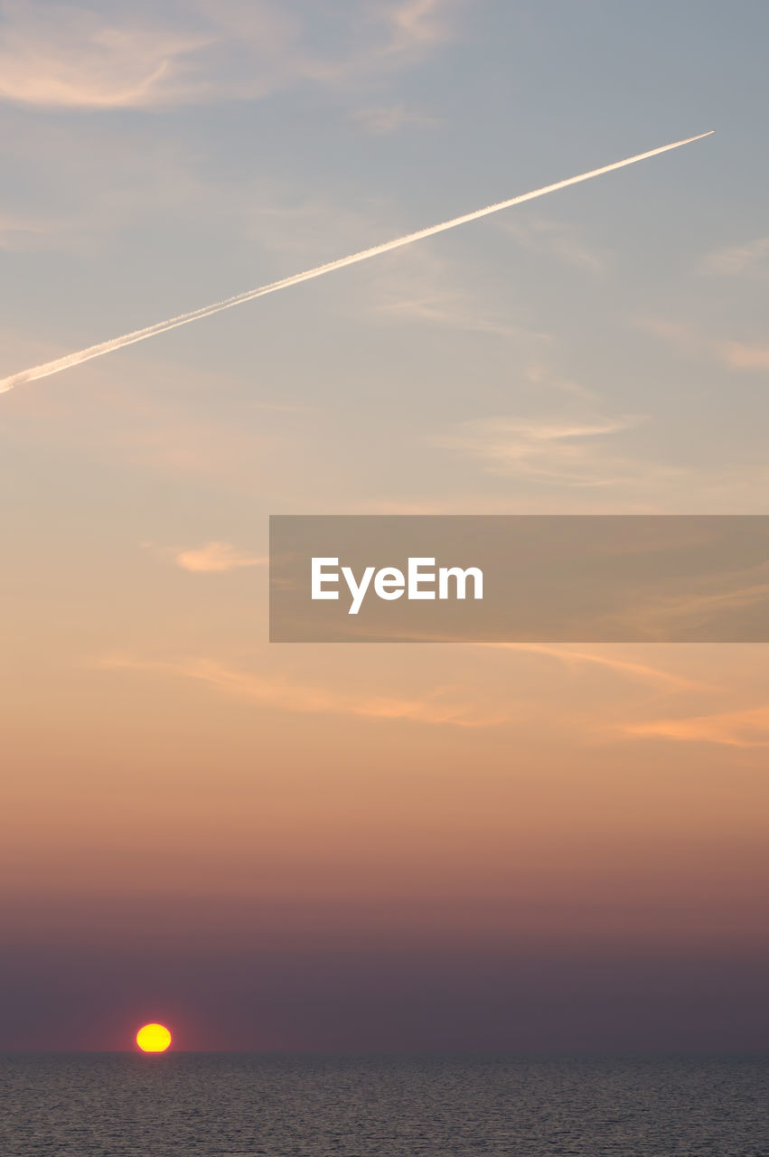 Scenic view of sea against romantic sky at sunset