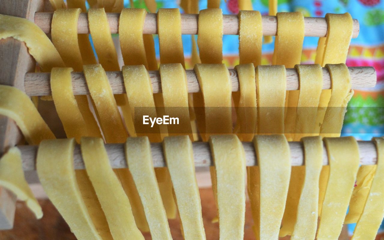 High angle view of raw spaghetti on wooden rods